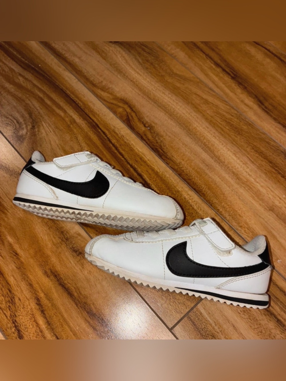 Kids White Cortez Sneakers with Black Swoosh - Classic Athletic Style